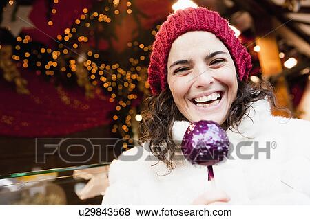 Woman holding candied apple View Large Photo Image Stock Photo - Woman holding candied apple. Fotosearch