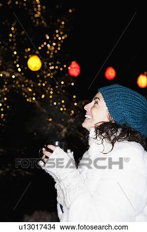 Woman holding cup watching the night sky View Large Photo Image Picture - Woman holding cup watching the night sky. Fotosearch