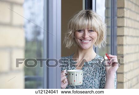 Woman holding keys to her new apartment View Large Photo Image Stock Image - Woman holding keys to her new apartment. Fotosearch