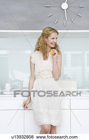 Stock Photo - Woman holding lemon. Fotosearch