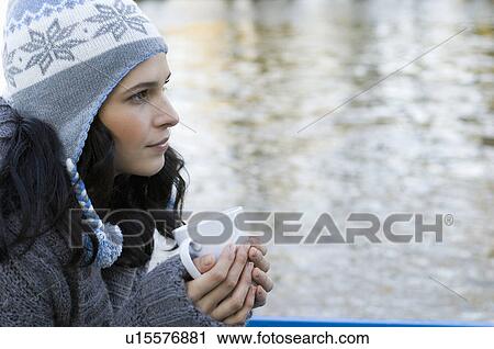 Stock Image - Woman holding mug. Fotosearch