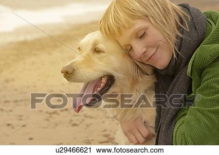 Woman hugging dog on beach View Large Photo Image Stock Image - Woman hugging dog on beach. Fotosearch