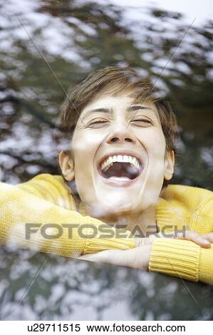 Stock Photography - Woman in a car laughing. Fotosearch