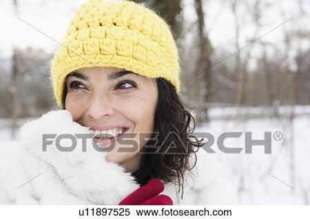 Woman in snowy woods wearing yellow cap View Large Photo Image Stock Photography - Woman in snowy woods wearing yellow cap. Fotosearch
