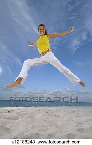 Woman jumping on beach View Large Photo Image Stock Photo - Woman jumping on beach. Fotosearch