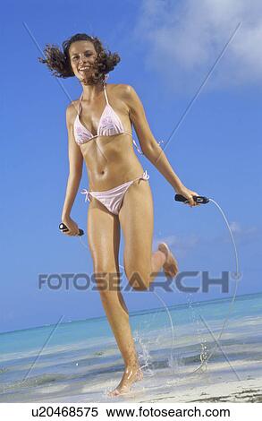 Woman jumping on beach View Large Photo Image Stock Photography - Woman jumping on beach. Fotosearch