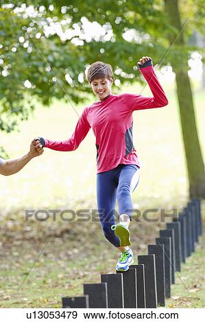 Stock Photo - Woman jumping post during workout. Fotosearch