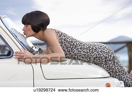 Woman kissing a car View Large Photo Image Picture - Woman kissing a car. Fotosearch