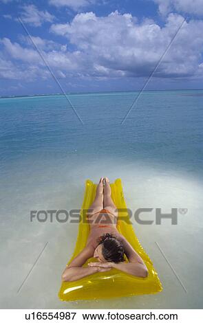 Woman laying on air mattress View Large Photo Image Stock Photo - Woman laying on air mattress. Fotosearch