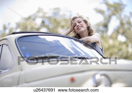 Woman leaning on a car View Large Photo Image Stock Image - Woman leaning on a car. Fotosearch