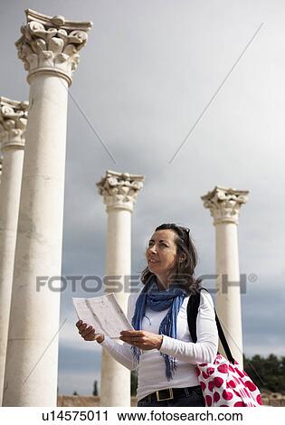 Stock Image - Woman looking at Roman ruins. Fotosearch