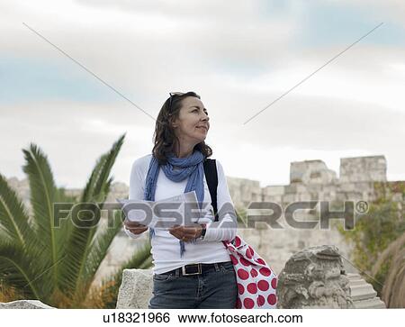 Woman looking at ruined buildings View Large Photo Image Stock Photograph - Woman looking at ruined buildings. Fotosearch