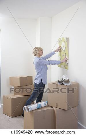 Woman looking at wallpaper samples View Large Photo Image Stock Image - Woman looking at wallpaper samples. Fotosearch