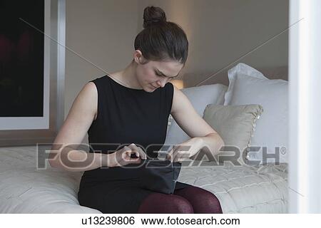 Woman looking in makeup bag View Large Photo Image Stock Photograph - Woman looking in makeup bag. Fotosearch