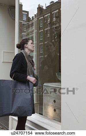 Picture - Woman looking in shop window. Fotosearch