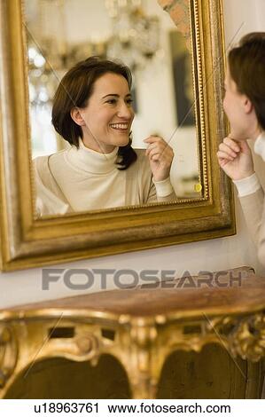 Woman looking into mirror View Large Photo Image Stock Image - Woman looking into mirror. Fotosearch