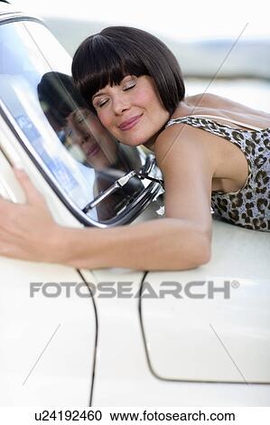 Woman loving her car View Large Photo Image Stock Image - Woman loving her car. Fotosearch
