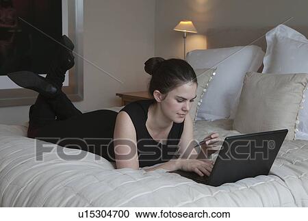 Stock Image - Woman making on line payment. Fotosearch