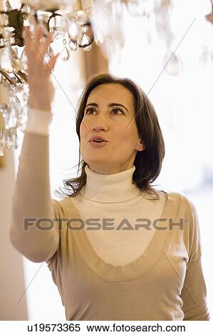 Stock Photography - Woman marveling at candelabrum. Fotosearch