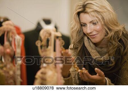 Stock Photo - Woman marveling at offers. Fotosearch
