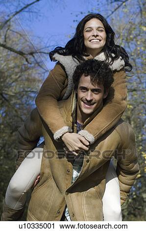 Stock Image - Woman on man's back. Fotosearch