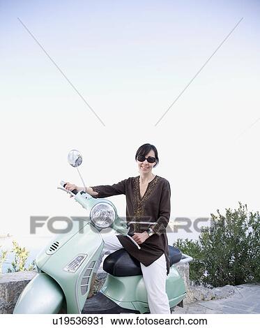 Stock Image - Woman on motorcycle. Fotosearch