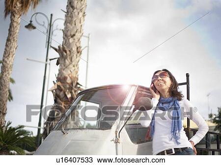 Woman on phone by small van View Large Photo Image Stock Image - Woman on phone by small van. Fotosearch