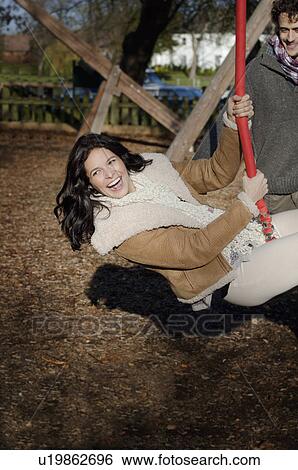 Woman on swing View Large Photo Image Stock Photograph - Woman on swing. Fotosearch