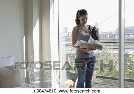 Woman opening parcel View Large Photo Image Stock Image - Woman opening parcel. Fotosearch