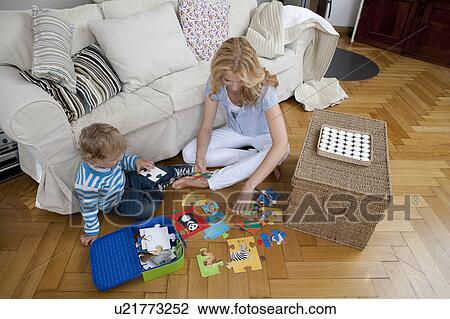 Woman playing on floor with son View Large Photo Image Stock Image - Woman playing on floor with son. Fotosearch