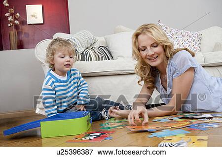 Woman playing on floor with son View Large Photo Image Stock Photo - Woman playing on floor with son. Fotosearch