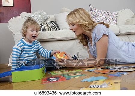 Woman playing on floor with son View Large Photo Image Stock Photograph - Woman playing on floor with son. Fotosearch