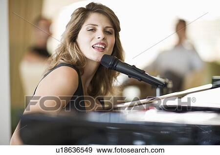 Woman playing piano View Large Photo Image Stock Photo - Woman playing piano. Fotosearch