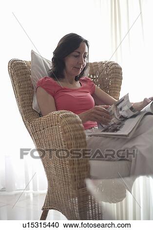 Stock Image - Woman reading magazine. Fotosearch