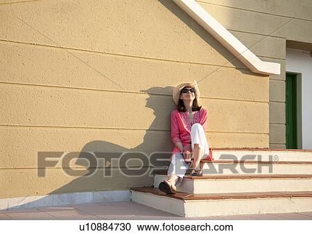 Woman relaxing in late afternoon sun View Large Photo Image Stock Image - Woman relaxing in late afternoon sun. Fotosearch
