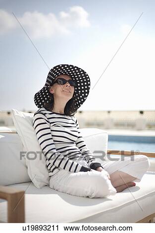 Woman relaxing in sunshine View Large Photo Image Stock Image - Woman relaxing in sunshine. Fotosearch
