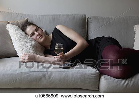 Woman relaxing on sofa View Large Photo Image Stock Photo - Woman relaxing on sofa. Fotosearch
