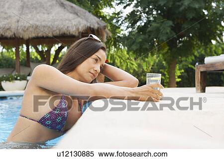 Woman relaxing with drink in hotel pool View Large Photo Image Stock Photography - Woman relaxing with drink in hotel pool. Fotosearch
