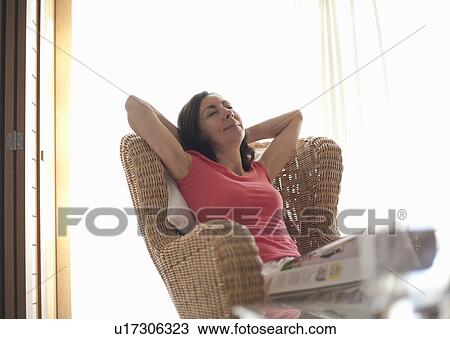 Woman relaxing with magazine View Large Photo Image Stock Image - Woman relaxing with magazine. Fotosearch