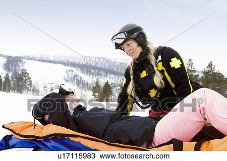 Woman Rescuer with Skier View Large Photo Image Stock Image - Woman Rescuer with Skier. Fotosearch