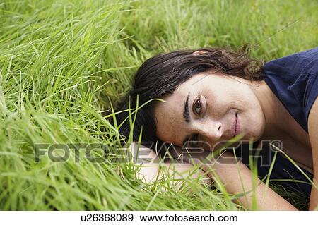 Woman resting in meadow View Large Photo Image Stock Photo - Woman resting in meadow. Fotosearch