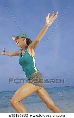 Woman running on beach View Large Photo Image Stock Image - Woman running on beach. Fotosearch