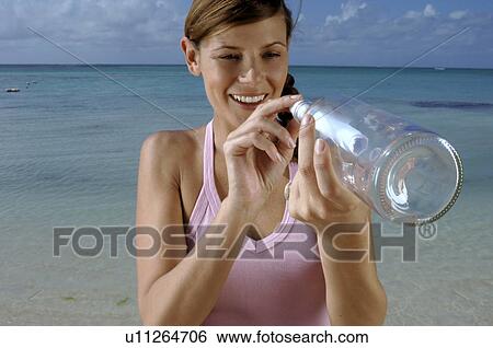 Woman sending postbottle View Large Photo Image Stock Photograph - Woman sending postbottle. Fotosearch