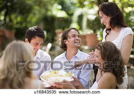 Stock Photography - Woman serving pasta. Fotosearch