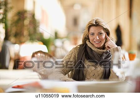 Woman sitting in restaurant View Large Photo Image Stock Photo - Woman sitting in restaurant. Fotosearch