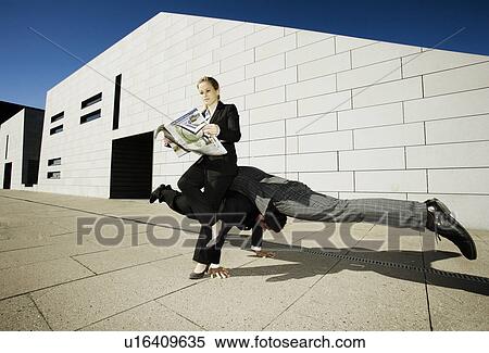 Stock Photography - Woman sitting on 2 men. Fotosearch