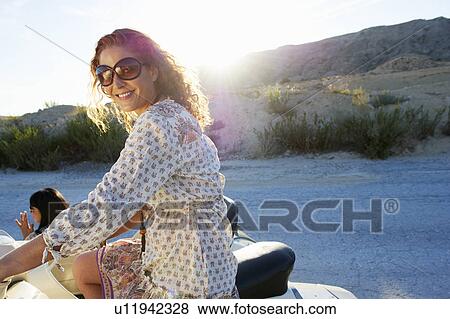 Woman sitting on a motorbike View Large Photo Image Stock Photo - Woman sitting on a motorbike. Fotosearch