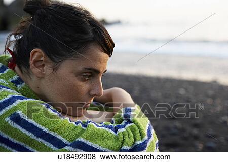 Woman sitting on beach View Large Photo Image Stock Photo - Woman sitting on beach. Fotosearch