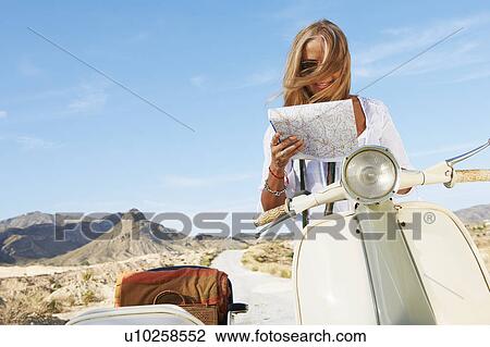 Woman Sitting on motorbike with map View Large Photo Image Stock Image - Woman Sitting on motorbike with map. Fotosearch