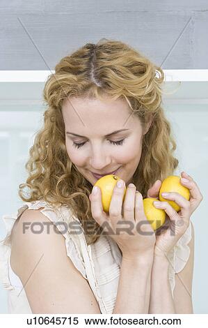 Woman smelling lemons View Large Photo Image Stock Photography - Woman smelling lemons. Fotosearch